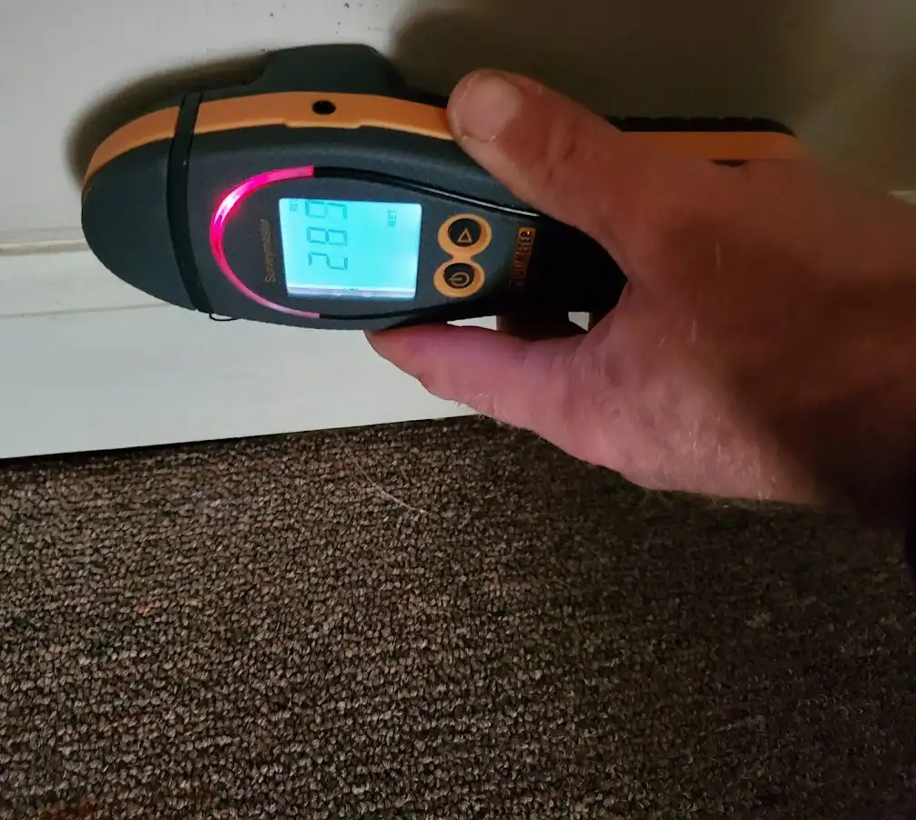 Moisture detection at baseboard during Storm Damage Restoration in Holmen